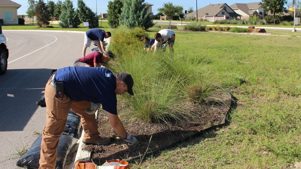 Volunteers planting a landscape